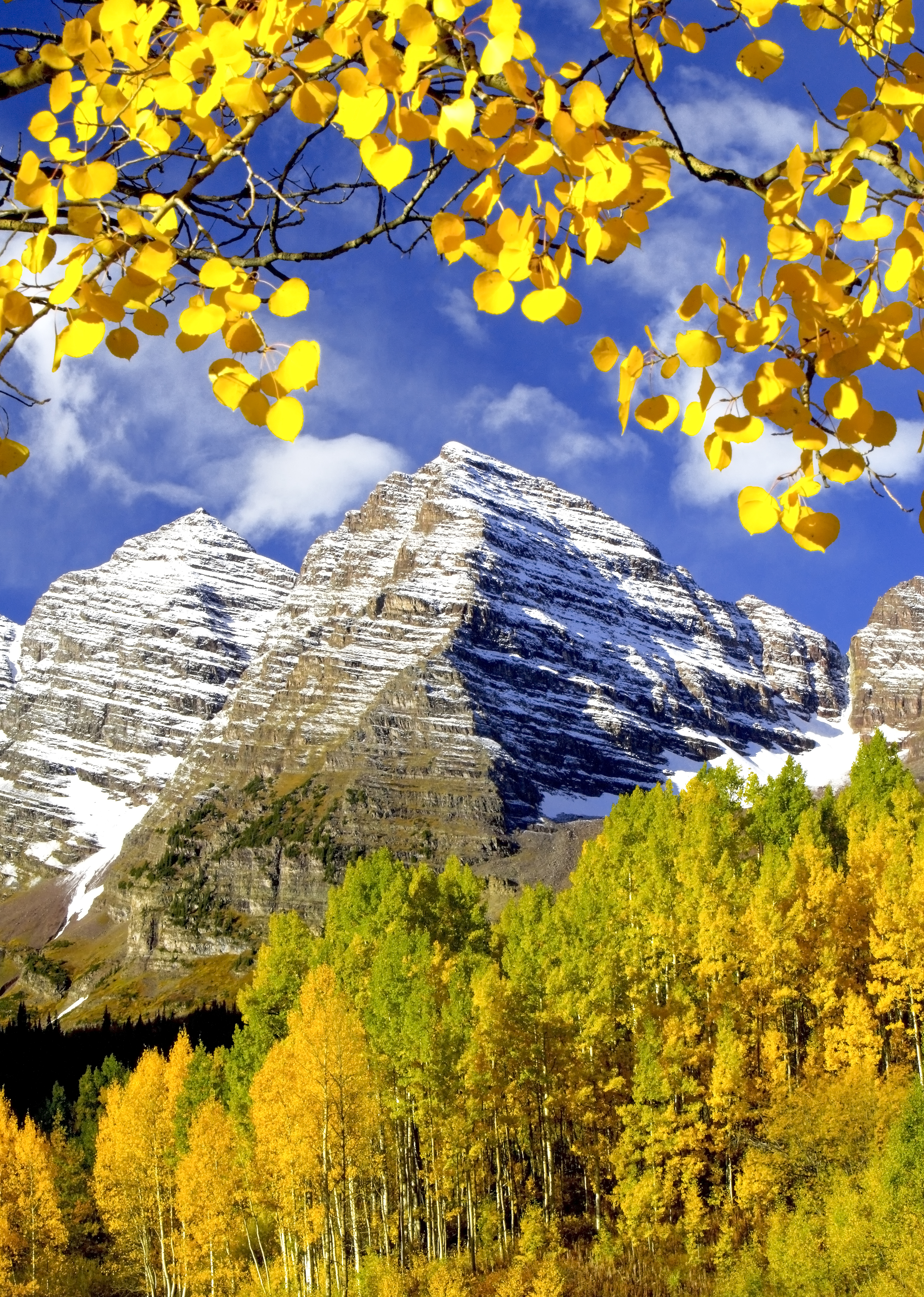 Autumn aspens below the Maroon Bells reflected in Maroon Lake, showing alpine geology, water, and seasonal color in Colorado