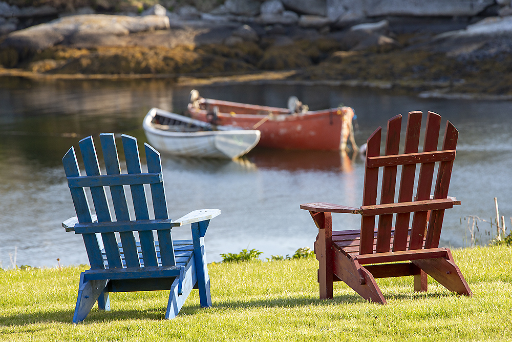 Traditional fishing harbor scene at Peggy’s Cove with colorful lobster traps, ropes, and coastal boats representing maritime ecosystem and human connection