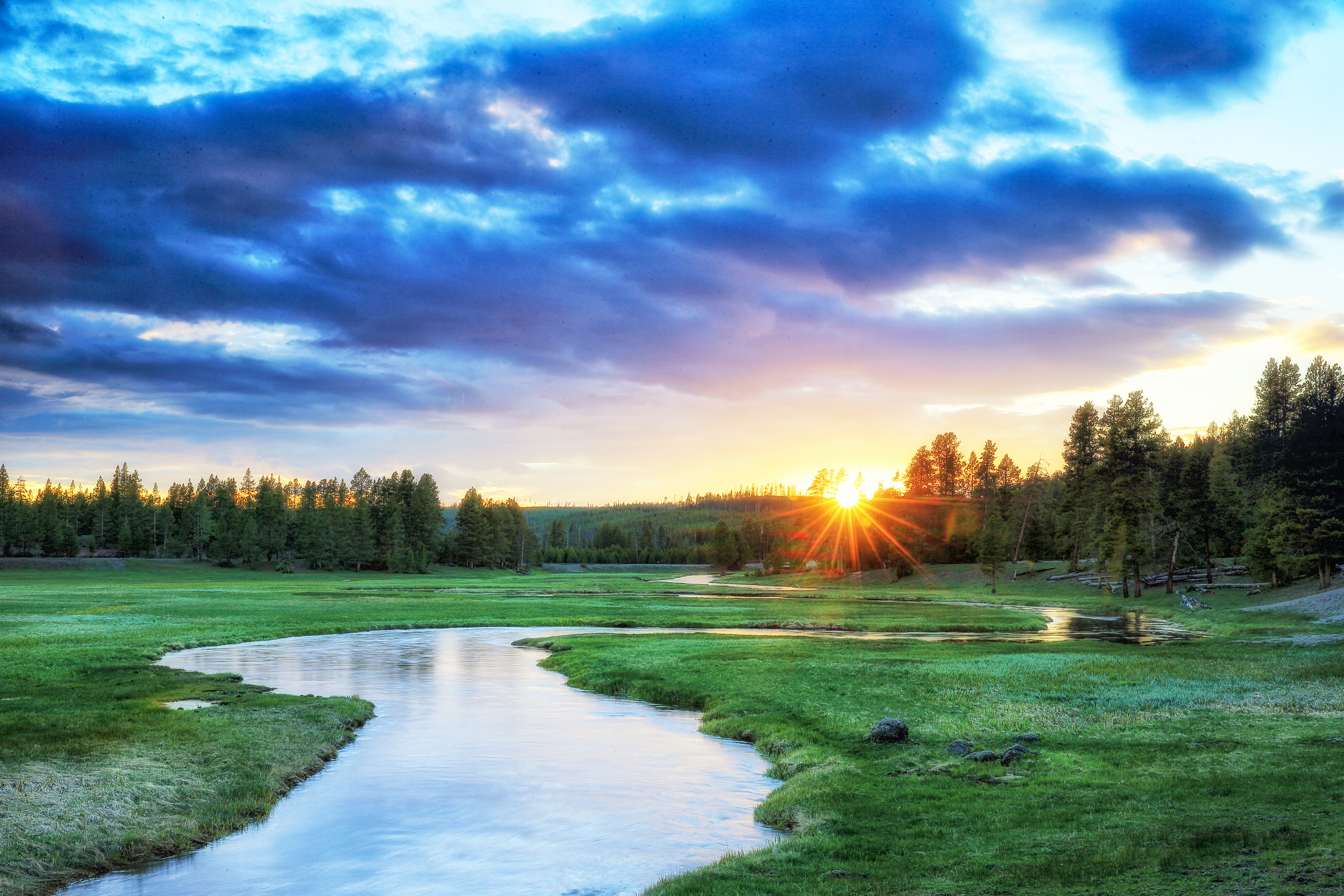 Soft river at dusk reflecting warm light in silence