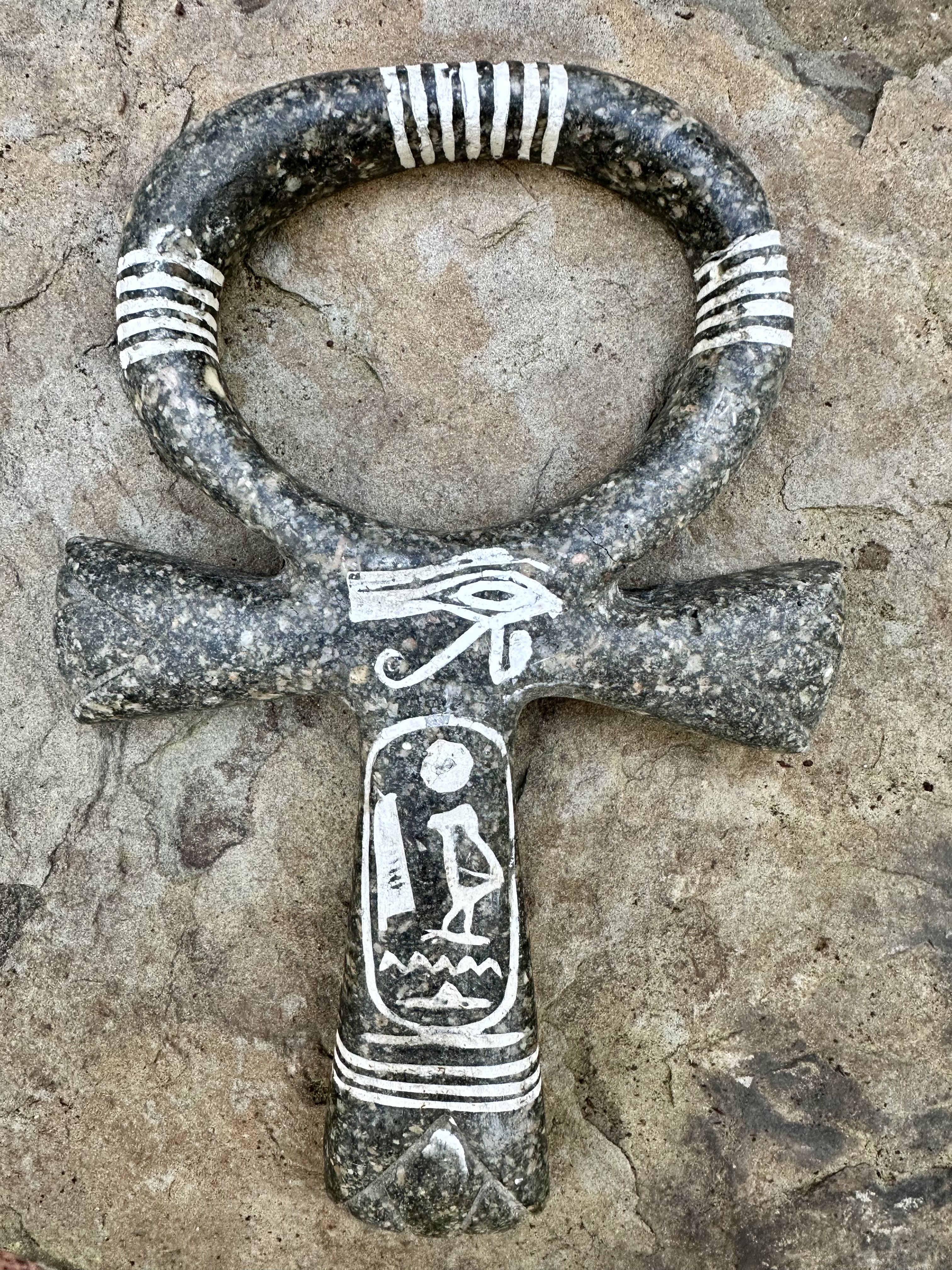 Stone-carved ankh with Eye of Horus and cartouche etched in white lines — symbol of toroidal resonance, polarity, and breath circuitry