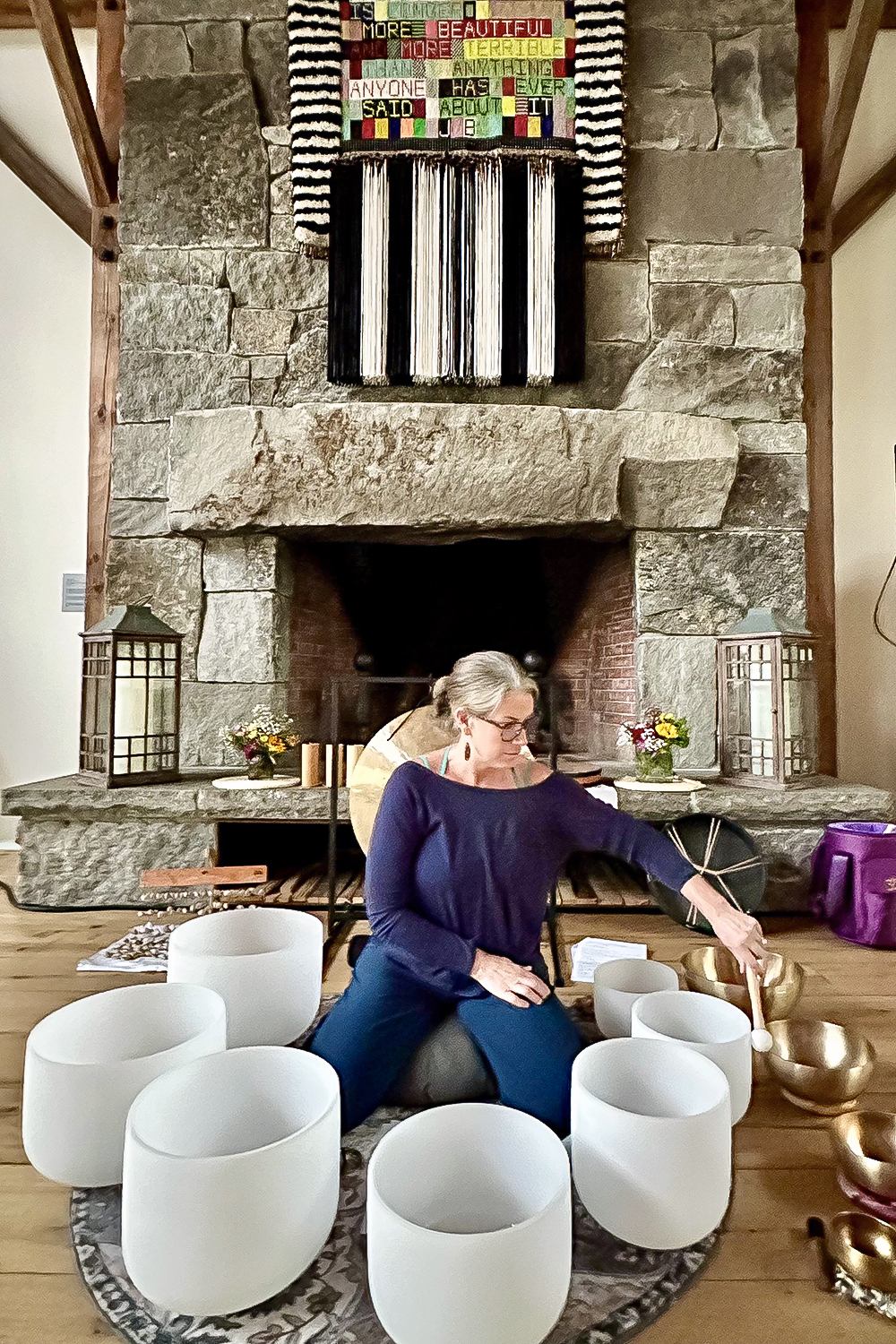 Katrina performing sound bowl therapy — light, resonance, and healing vibration