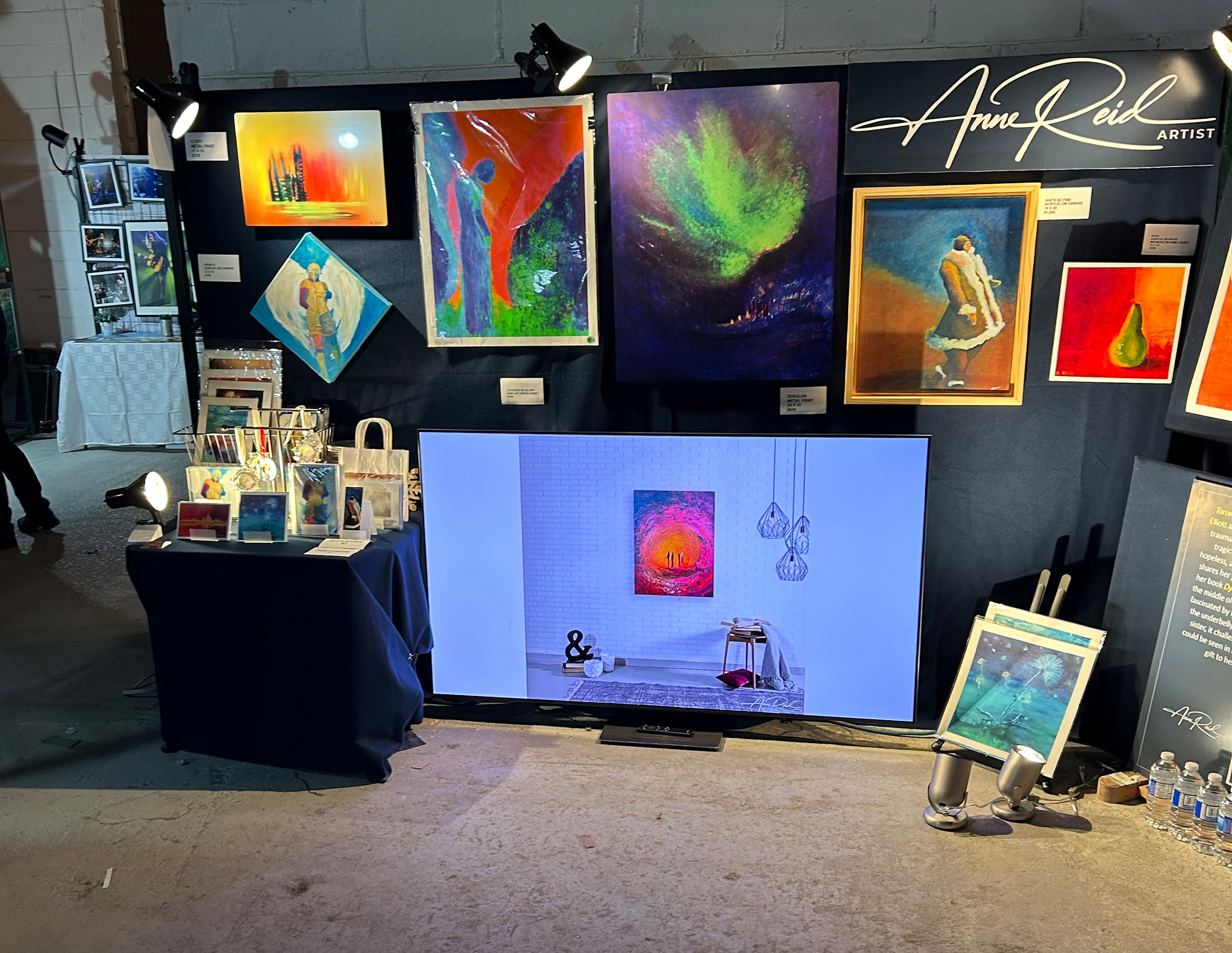 RAW Toronto Artshow booth showing featured works and display screen