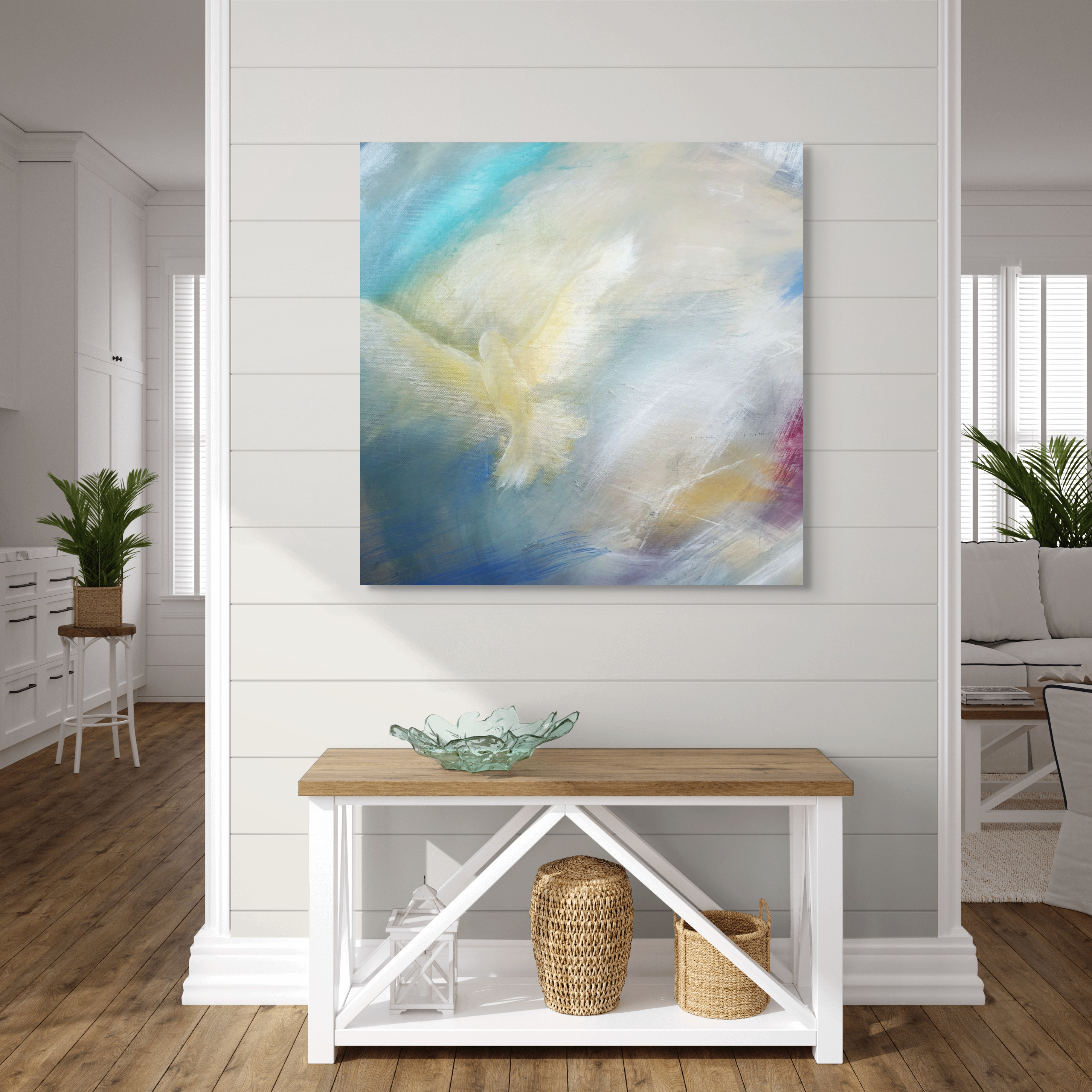 Dove fine art print by Anne Reid Artist displayed above a console table in a bright coastal-style entryway.