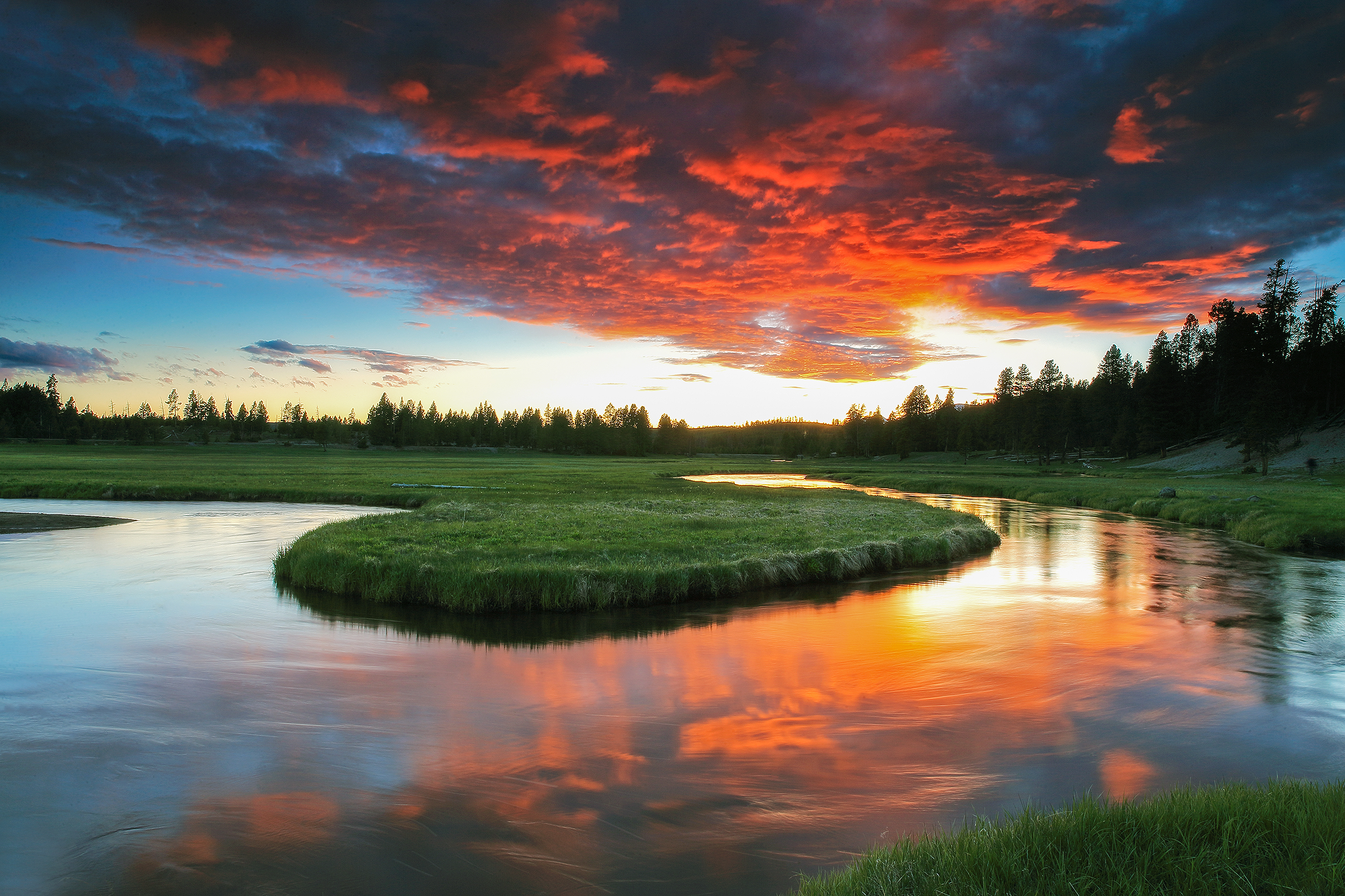 Yellowstone valley rising into morning—landscape shaped by centuries of fire, water, and breath