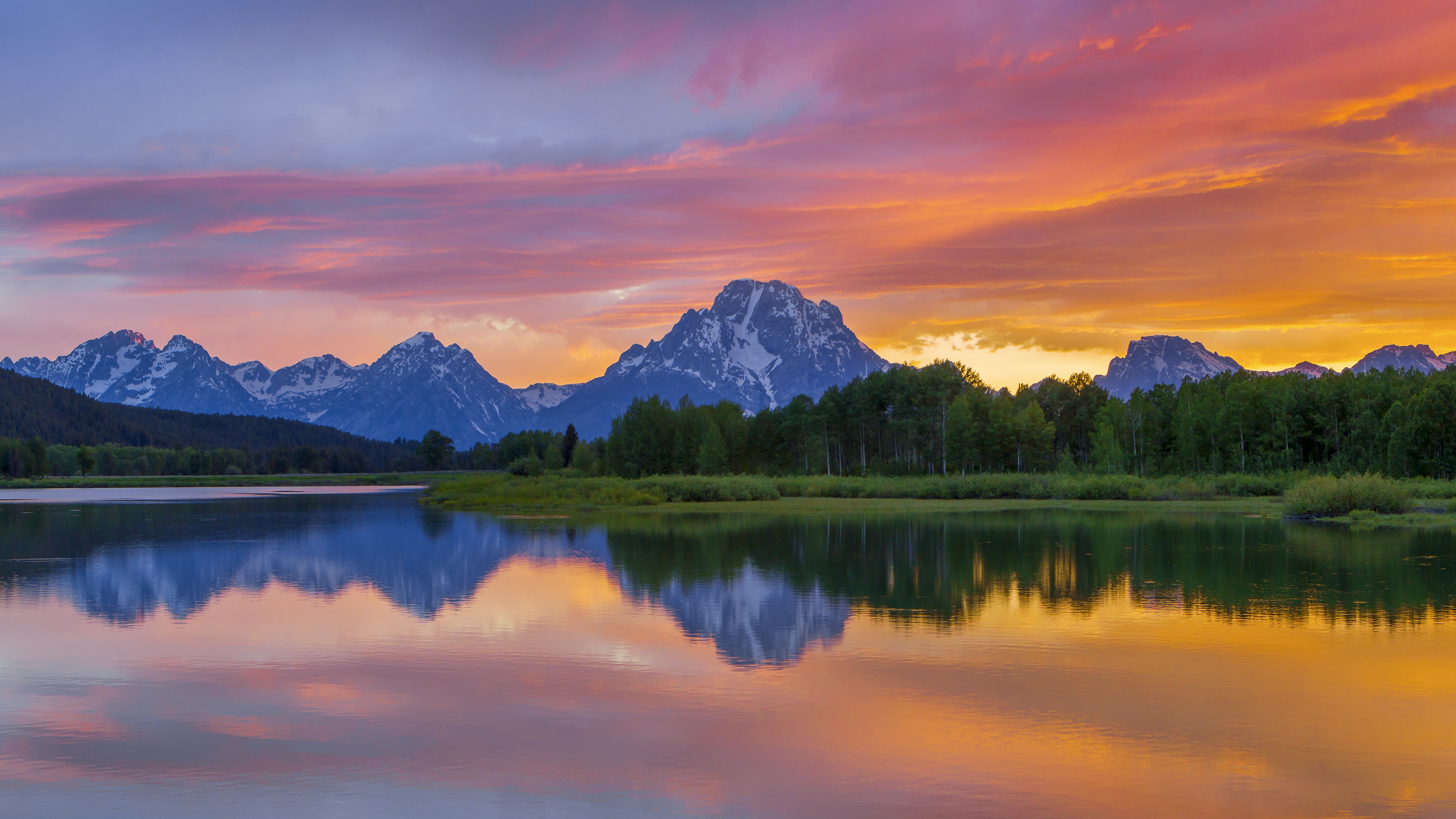 Sunset at Oxbow Bend with Mount Moran reflected in the Snake River in Grand Teton National Park.