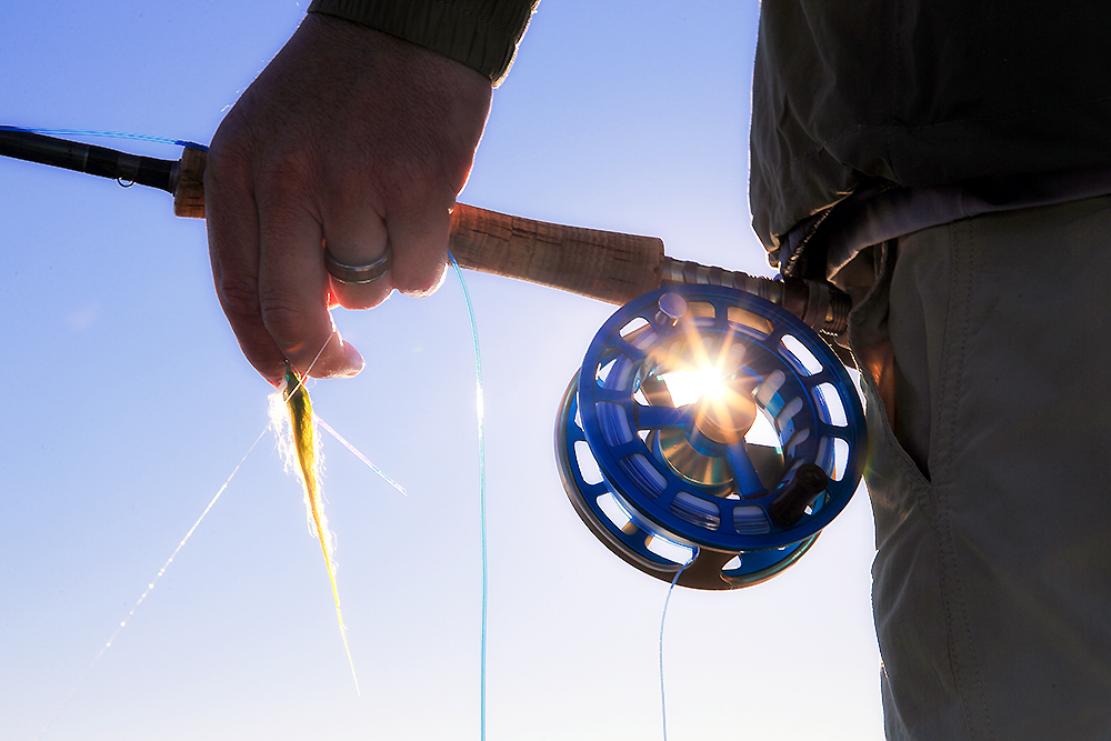 Fishing reel and rod at Montauk shoreline representing surfcasting culture and coastal discipline
