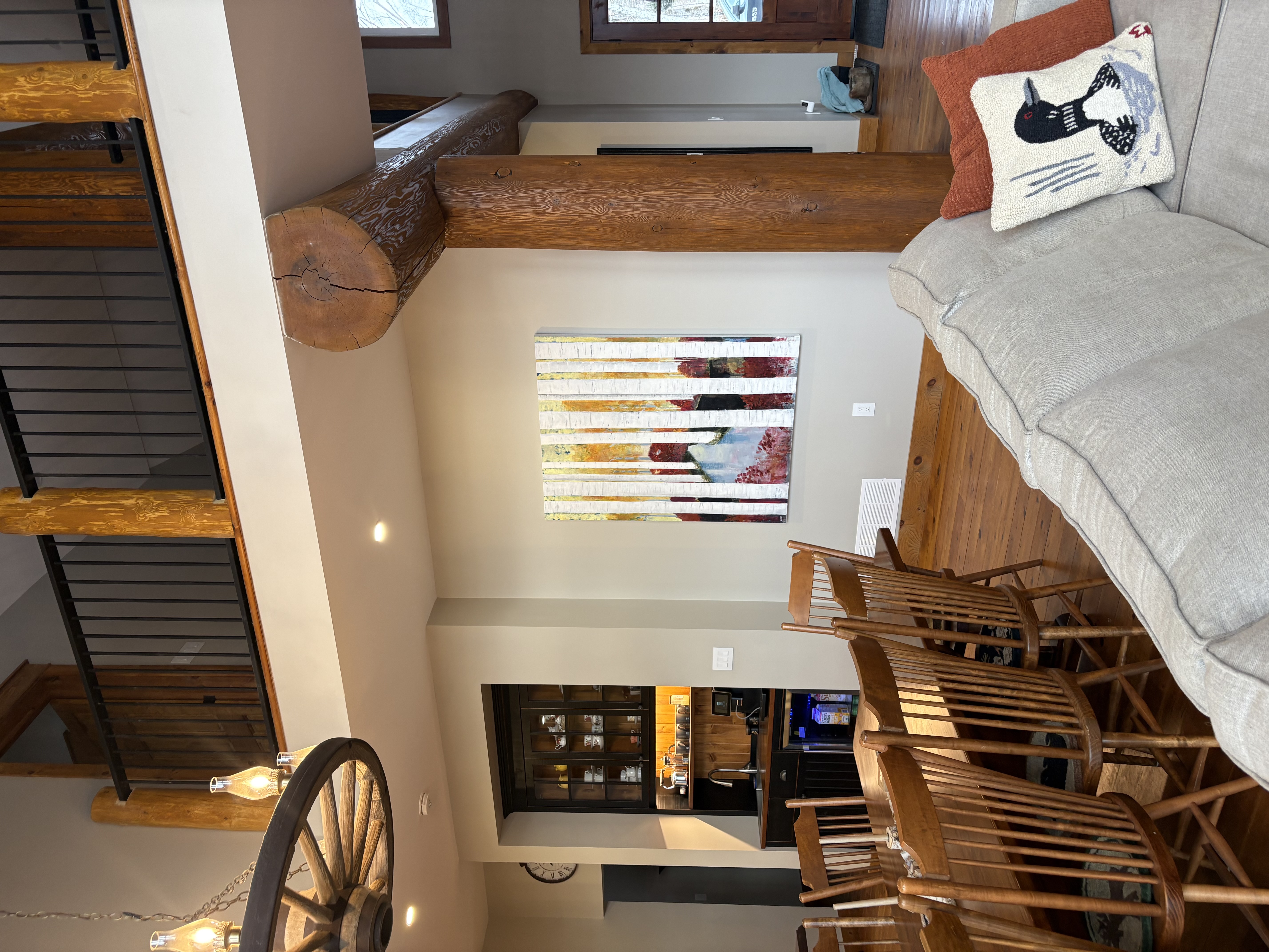 Yellow Wood acrylic painting by Anne Reid Artist installed in a cathedral-ceiling timber home open-concept living and dining space in Muskoka Ontario