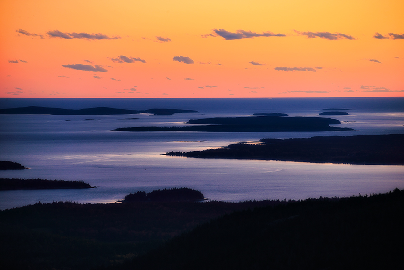 Autumn sunrise over Cadillac Mountain with colorful foliage and layered coastal light in Acadia National Park